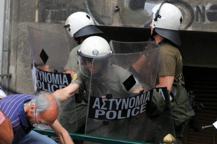 1280-20110629_Old_man_hit_by_Riot_Police_in_demonstrations_in_Athens_Greece